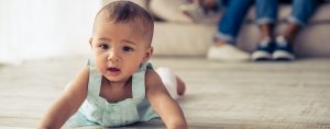 Baby Girl Crawling on a Wooden Floor