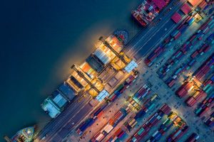 Container Cargo Ship and Cargo Plane in Shipyard at Sunrise